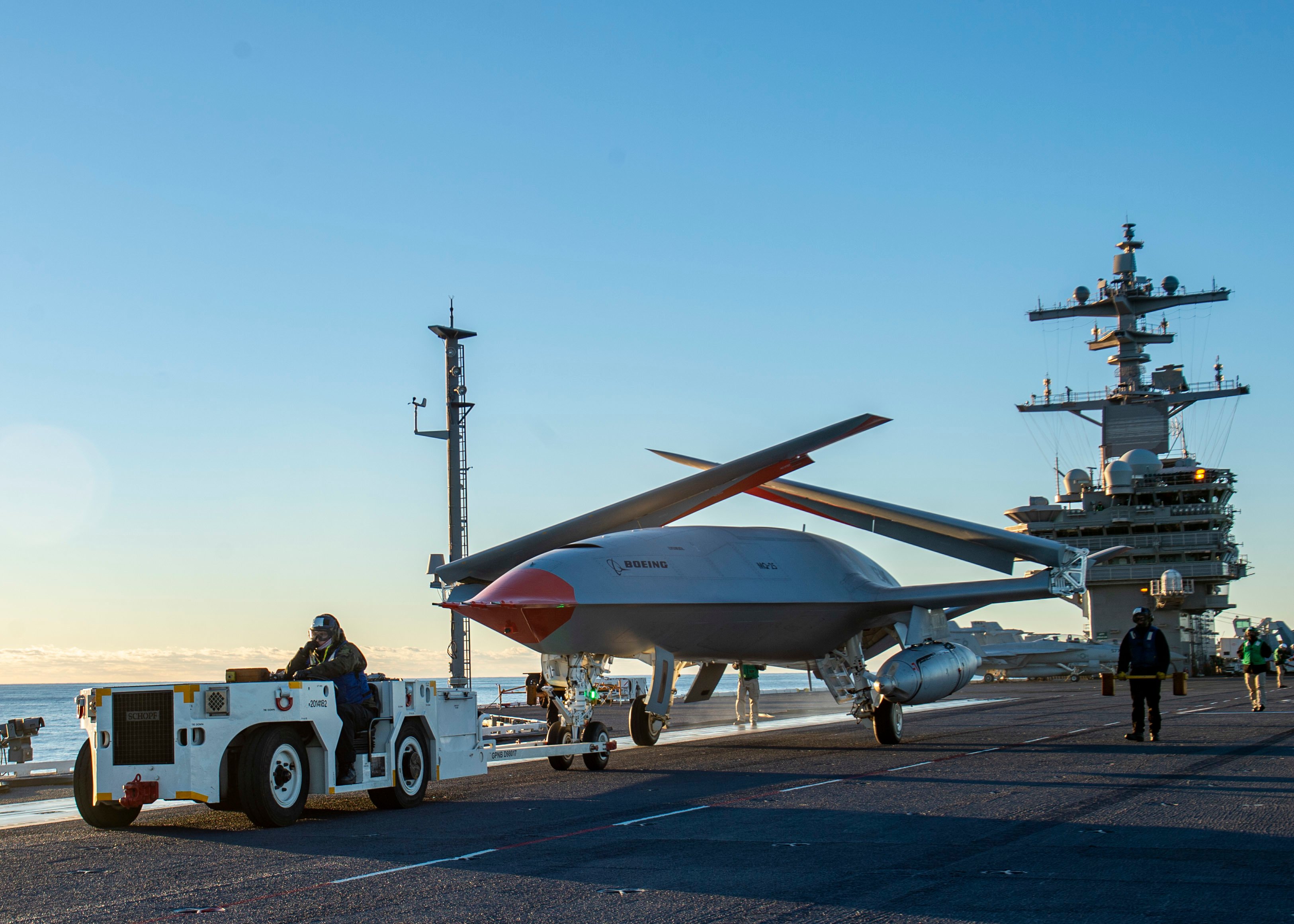 Boeing unmanned MQ-25 aircraft is given operating directions on the flight deck aboard the aircraft carrier USS George H.W. Bush (CVN 77) on Dec. 13, 2021 in the Atlantic Ocean..jpg