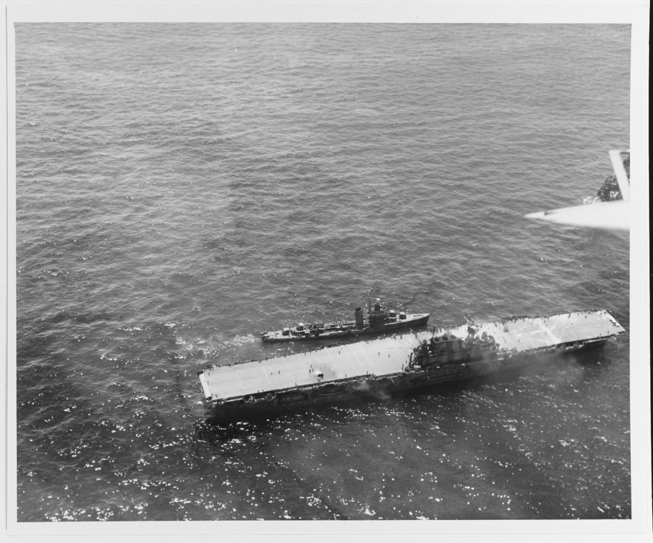 USS Hornet (CV-8) dead in the water with a destroyer alongside, 26 October 1942..jpg